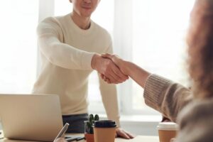 Woman and man shaking hands