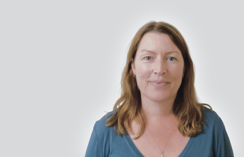 Woman with shoulder length brown hair smiling at the camera