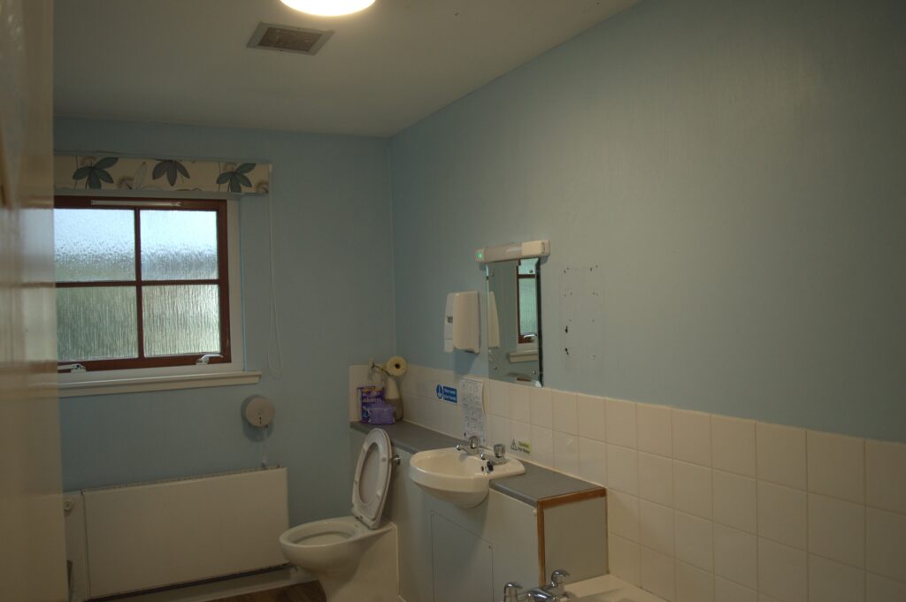 A bathroom with blue painted walls