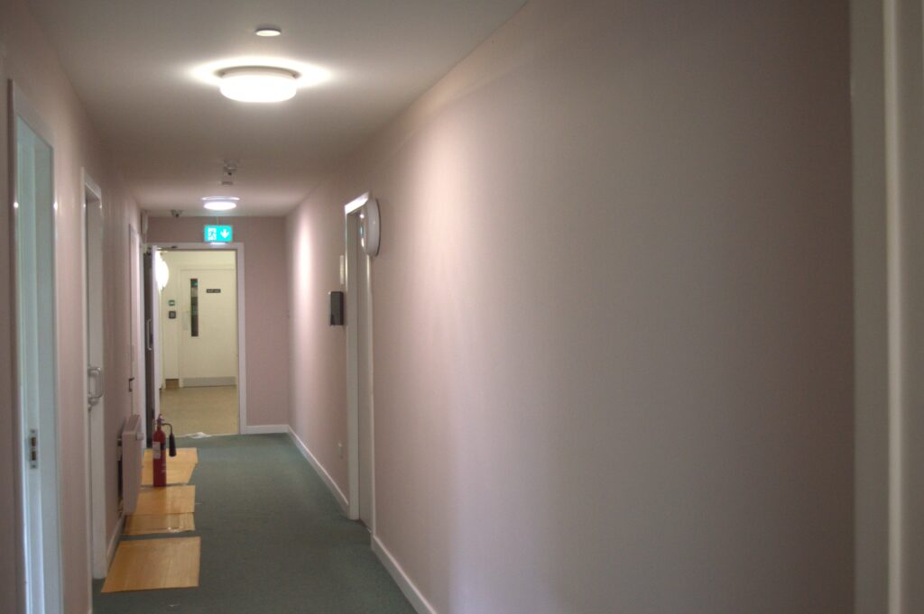 Corridor of a building with freshly painted pink walls