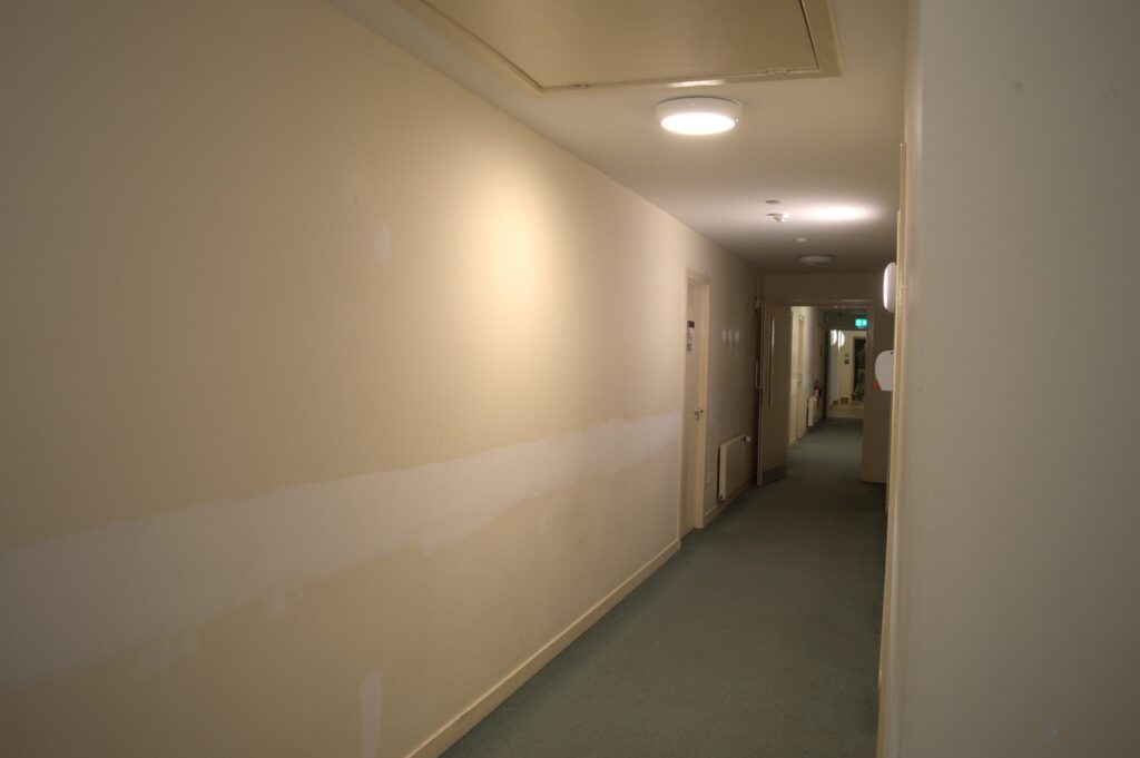 Corridor of a building with cream walls.