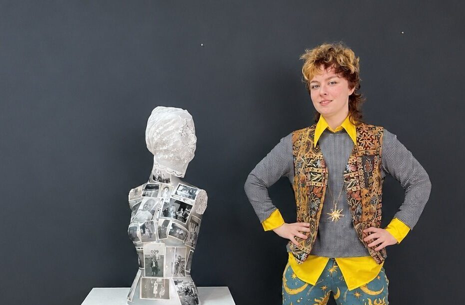 Artist standing beside a finished piece of 3D art